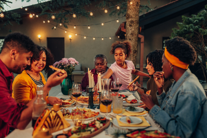 Family gathering over dinner with friends because it takes a village