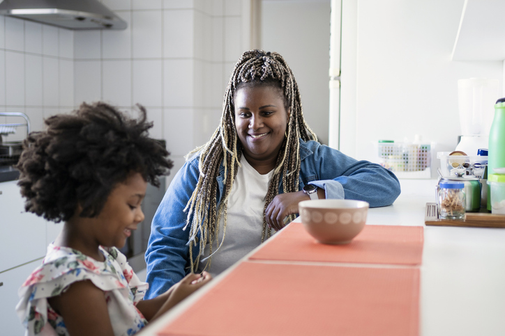 Aunt and niece eating in the kitchen