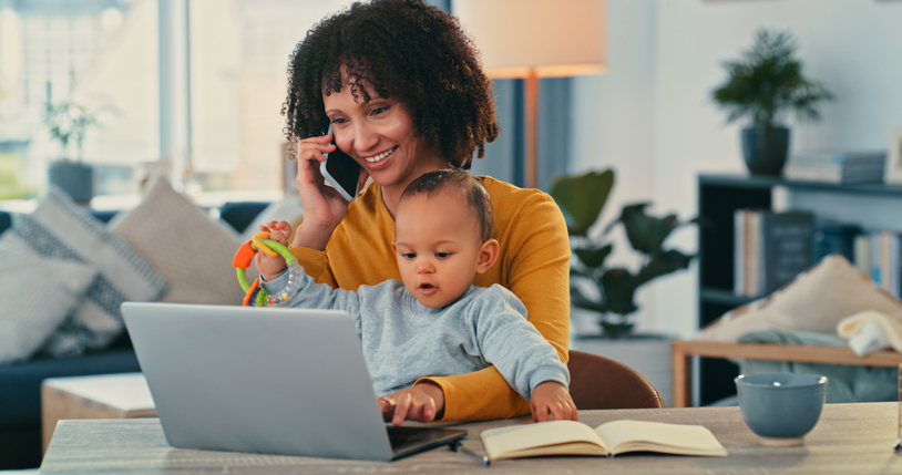 Shot of a young woman using a laptop and smartphone while caring for her adorable baby girl at home