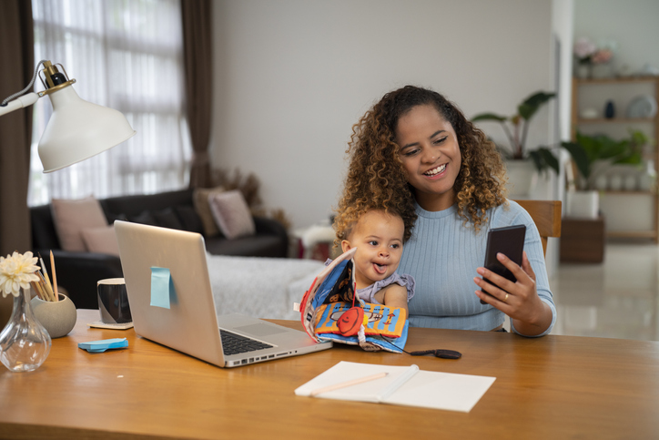 Mother with baby working at home