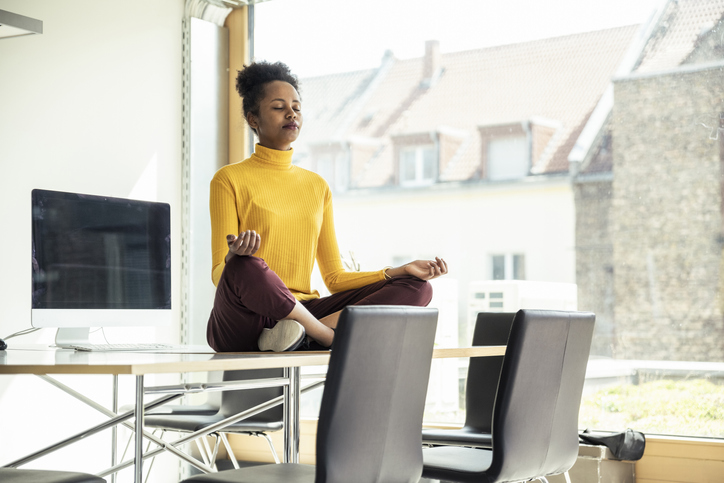Female professional meditating on National Relaxation Day