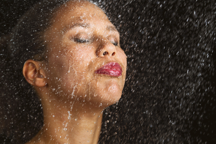 African american woman under shower after a bad night's sleep