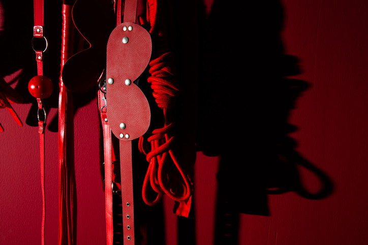 Close-Up Of Sex Toys Hanging Against Wall