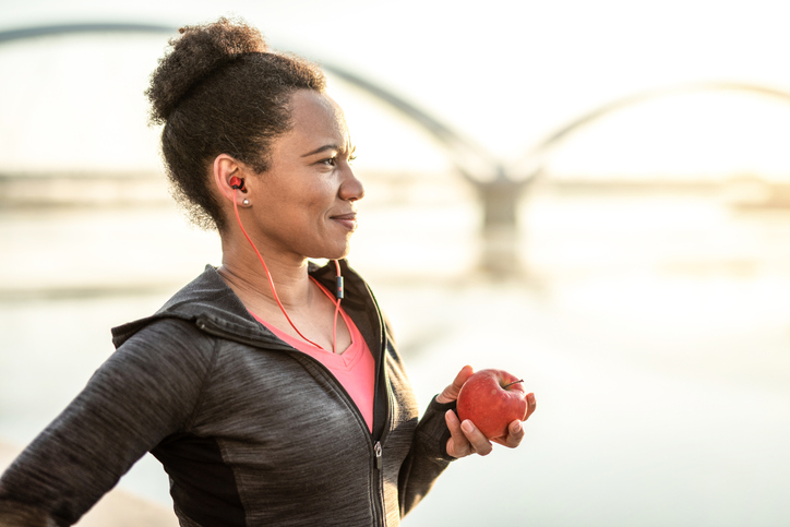 Sporty Woman Eating an Apple.