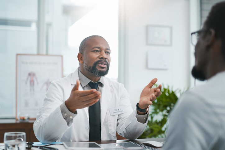 Shot of a mature doctor having a consultation with his patient