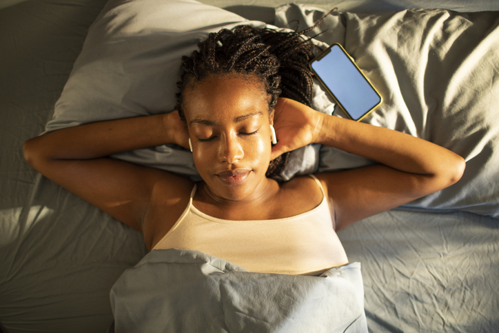 Young African woman waking up in the morning