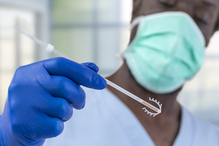 Doctor holding a copper IUD.