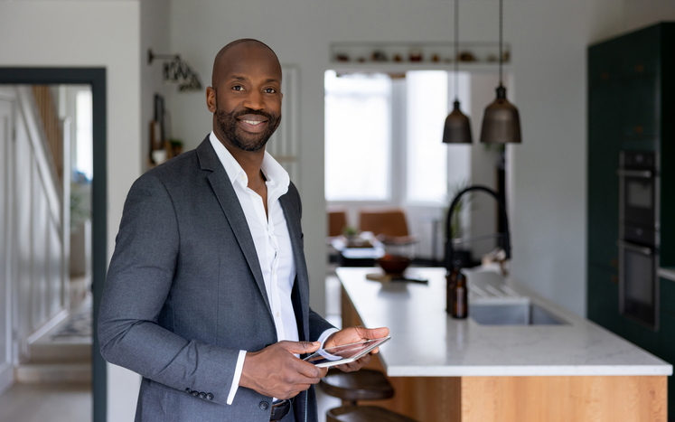 Happy real estate agent showing a property for sale