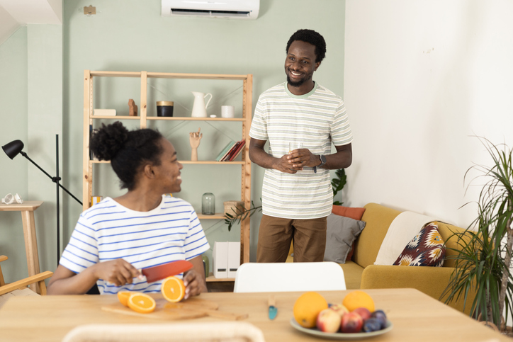 Happy African American couple having fresh fruit for a snack