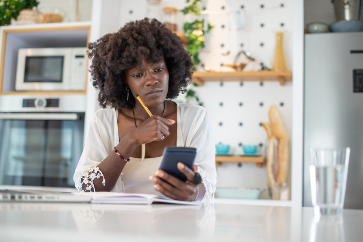 Woman planning home budget and using calculator stock photo