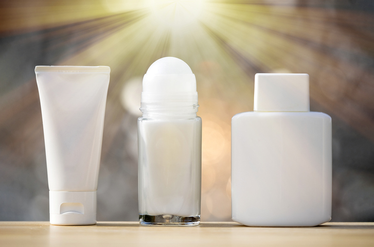 Deodorant and aftershave lotion container illuminated by sunlight.