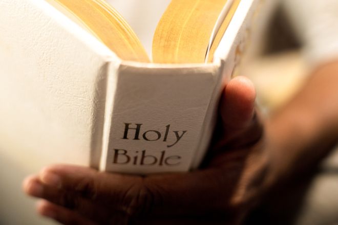black woman reading old family bible