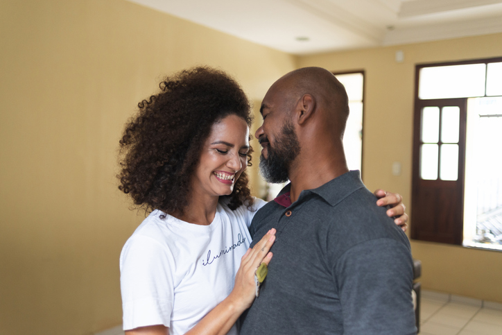 Portrait of an adult couple in their new home