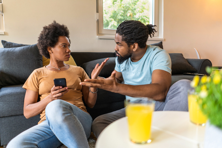 African American couple arguing at home about infidelity