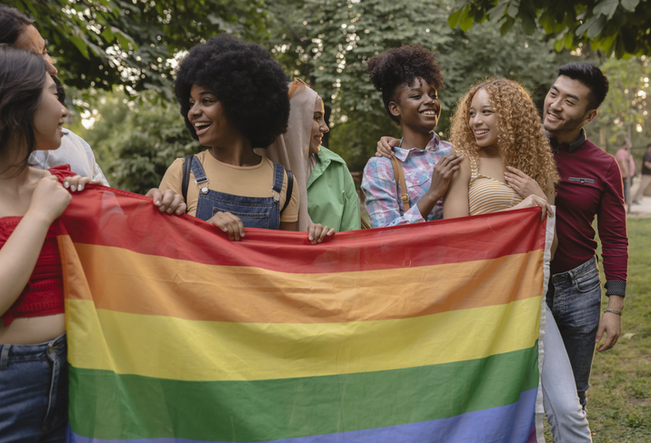 Multiracial LGBT friends with rainbow flag