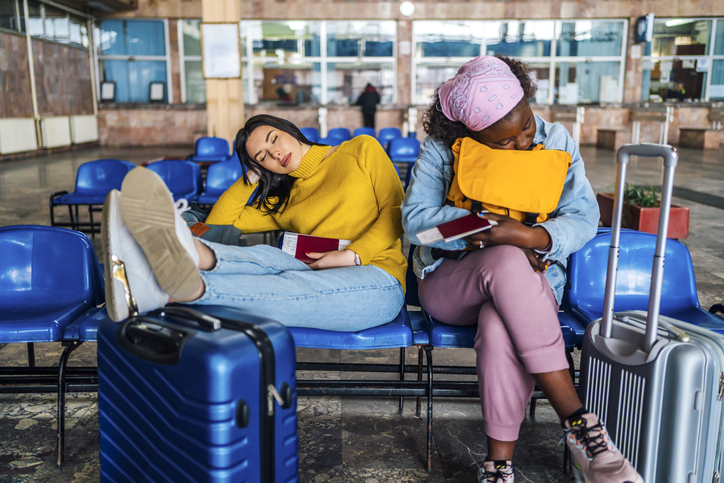 Young women traveler sleeping at railway station