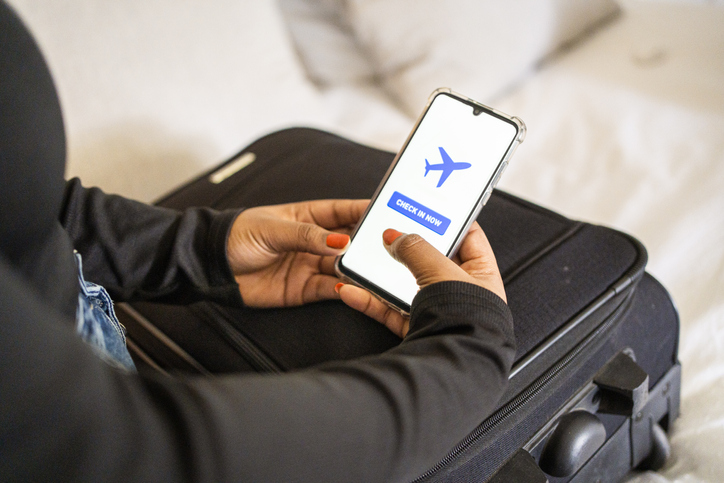 Young woman using an app to check-in for a flight