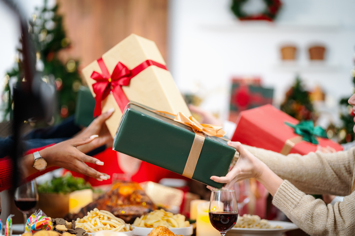 The family is happily exchanging gifts at Christmas.