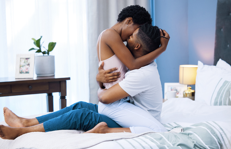 Shot of a young couple being intimate in bed at home