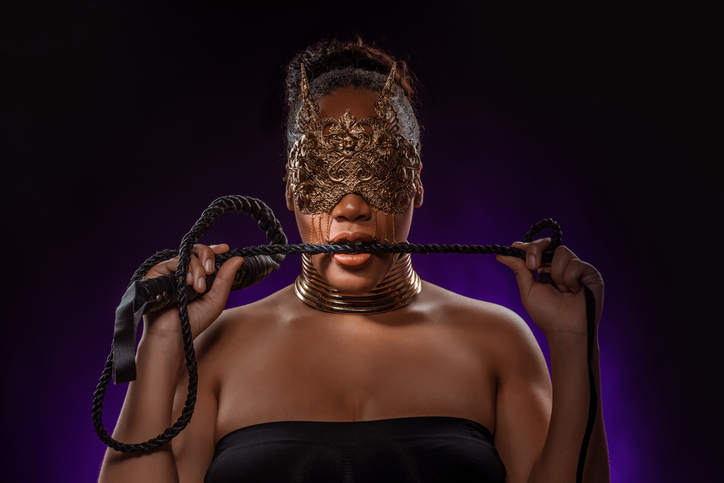 Portrait of a beautiful mixed race dominatrix woman