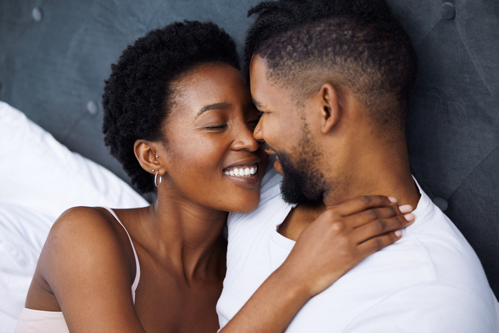 Shot of a young couple being intimate in bed at home