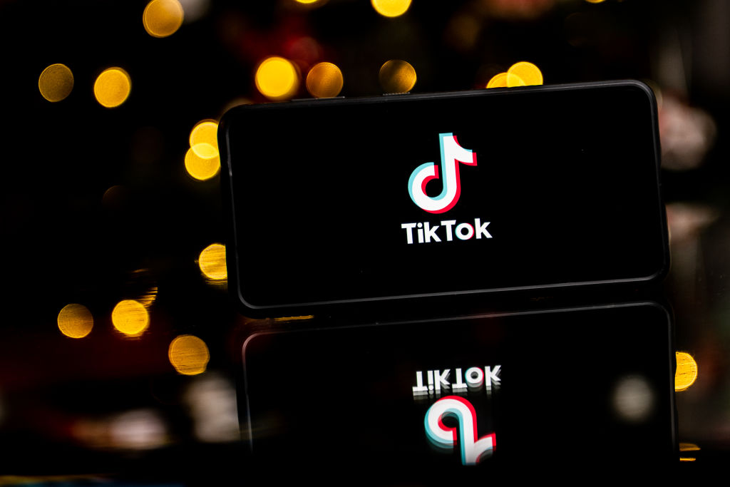 In this photo illustration a TikTok logo seen displayed on a...
