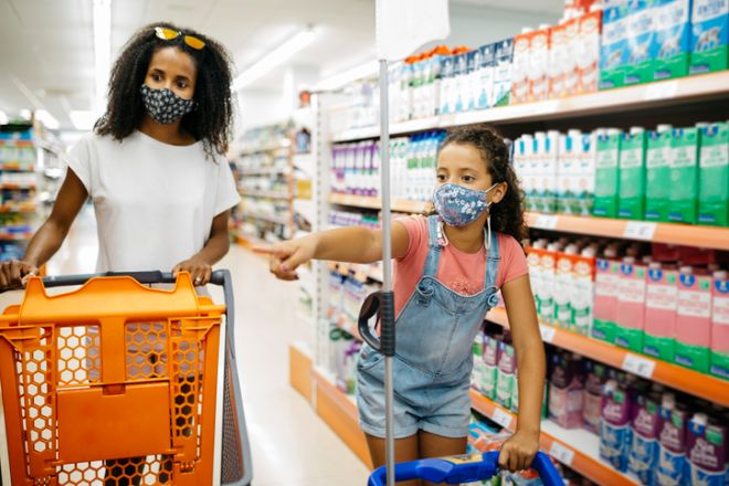 Mother and her daughter shopping in a supermarket
