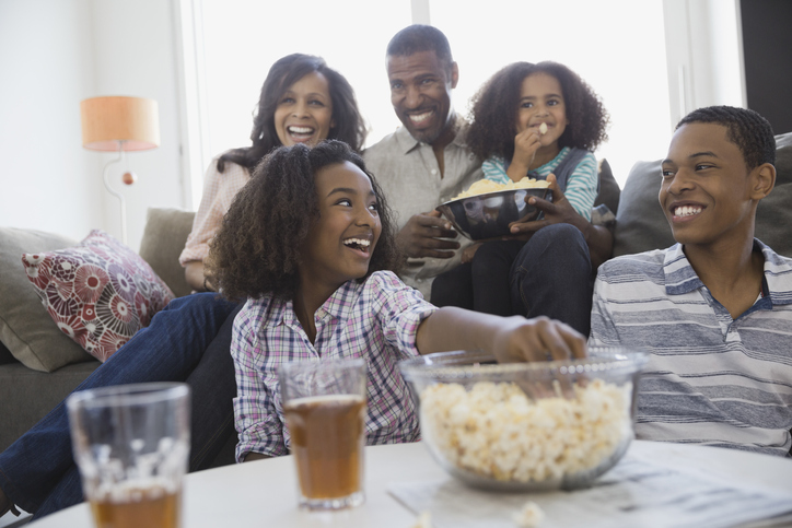 Family watching television together at home