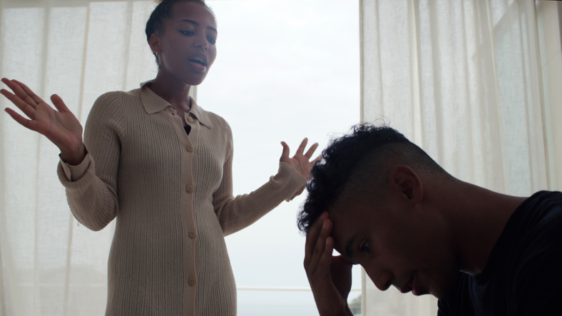 Unhappy african ethnicity couple arguing and yelling in the living room. Relationship breakup