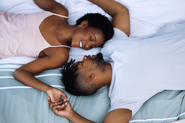 Shot of a young couple being intimate in bed at home