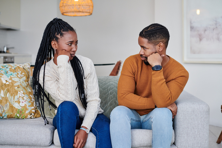 Shot of a young couple looking upset with each other at home arguing about a double date