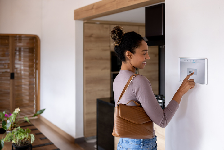 Woman leaving her smart home and closing the door using an automated system. living alone emergency safety
