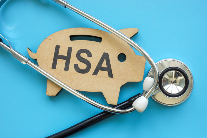 Piggy bank with sign HSA Health Savings Account and stethoscope.