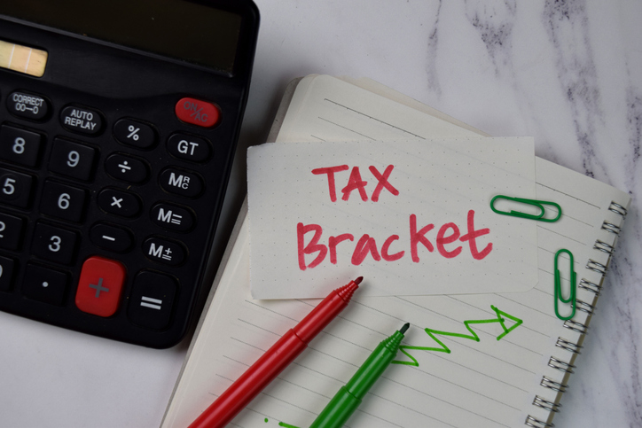 Tax Bracket text on sticky notes isolated on office desk.