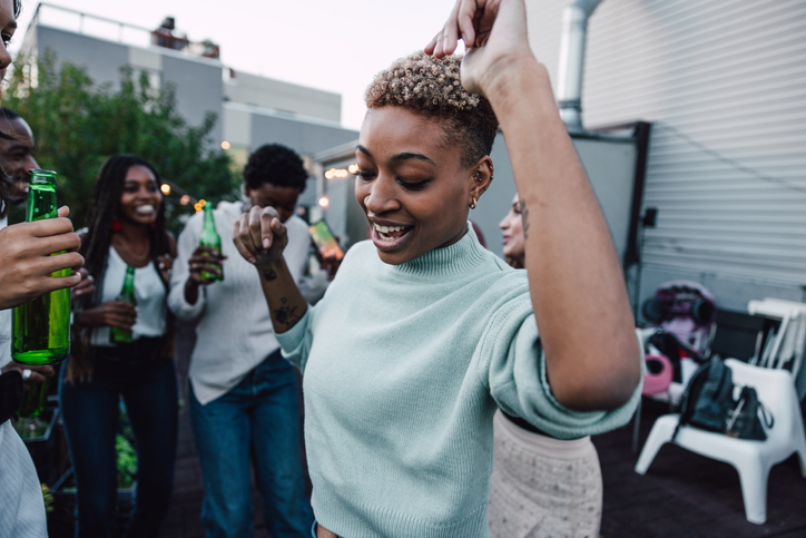 Woman dancing on a rooftop party
