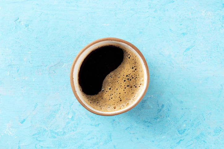 Coffee cup, overhead flat lay shot on a blue background