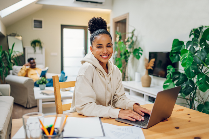 Portrait of a hispanic woman using laptop at home