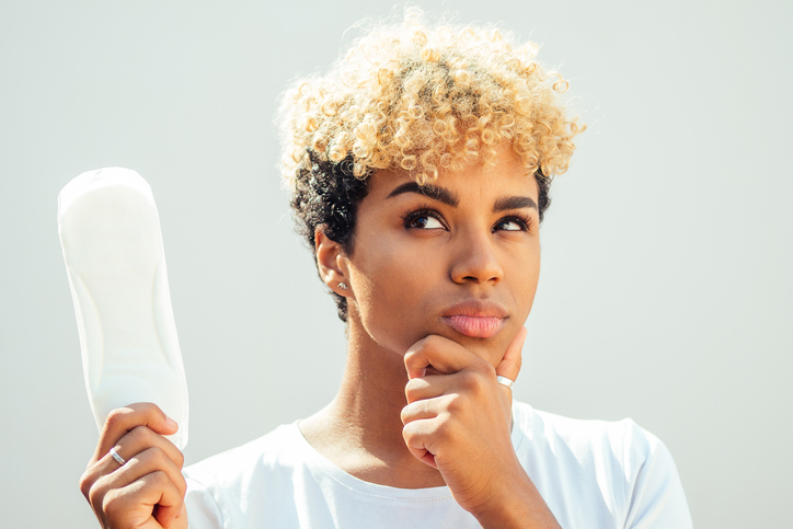 mixed race hispanic brazilian girl holding hygiene pad in studio white background and snow-white smile
