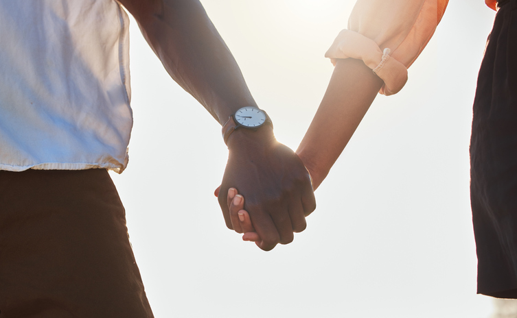 Love, flare and African couple holding hands, bonding and enjoy outdoor romantic quality time together. Peace, freedom and sunshine for calm black woman, man or people on marriage anniversary date