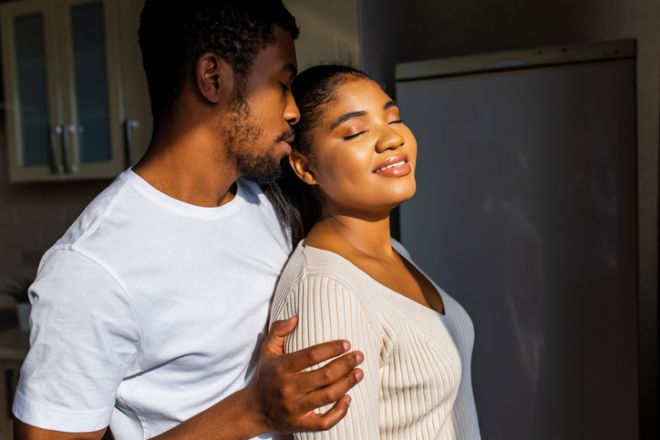 Young happy mixed race couple spending their time at home in the kitchen