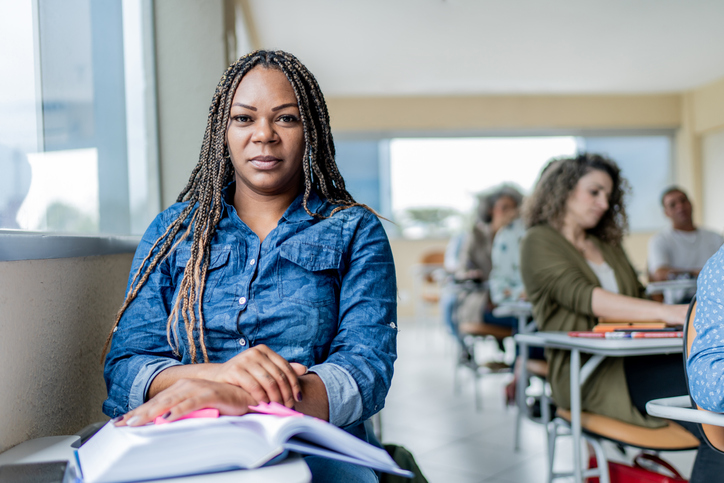 Portrait of adult black female student in classroom