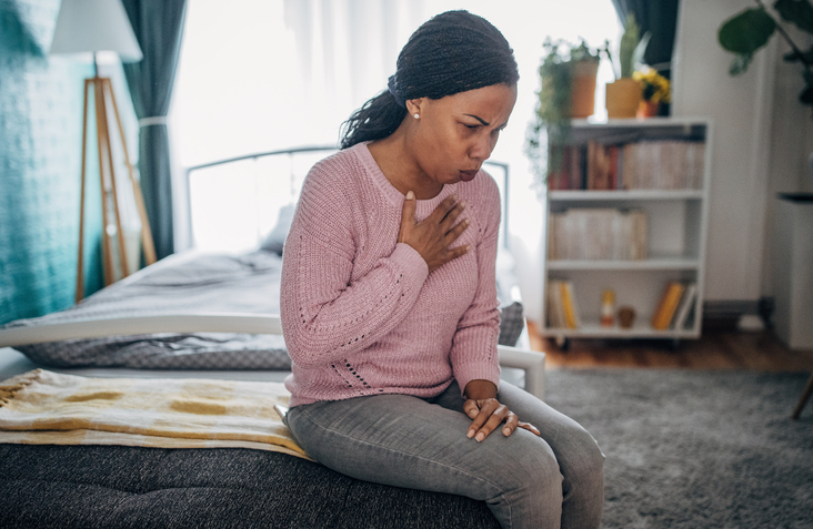 Woman having chest pain heart attack symptoms