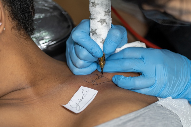professional doing a tattoo