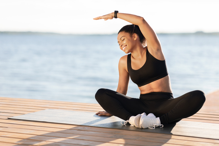 Happy sporty black lady enjoying her open-air workout