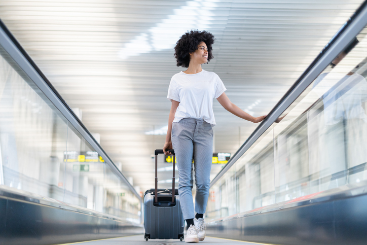 Happy young black woman in the airport