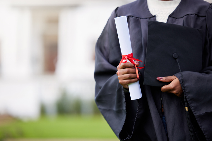 Closeup shot of an unrecognisable woman holding a certificate and cap on graduation day at ivy league schools 