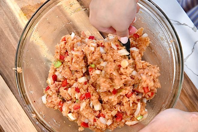 A bowl of the ground salmon mixture that will be formed into jerk salmon burger patties.