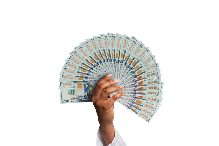 Business, banking, finance and saving concept. US dollars 100 in african american woman hand