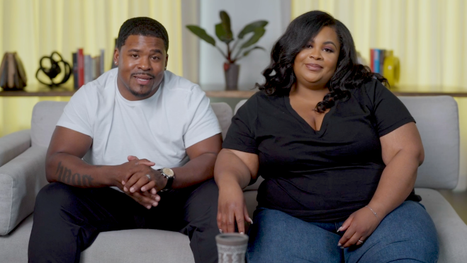 Video still of Tiera and Norman Belton sitting on a couch for the series Bliss on a Budget. They work with wedding and event producer Bianca Francois to plan the budget wedding of their dreams.