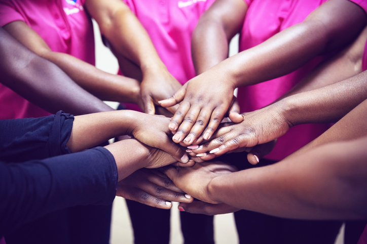 Unity and Togetherness - Young Women Joining Hands to Start The Breast Awareness Campaign
